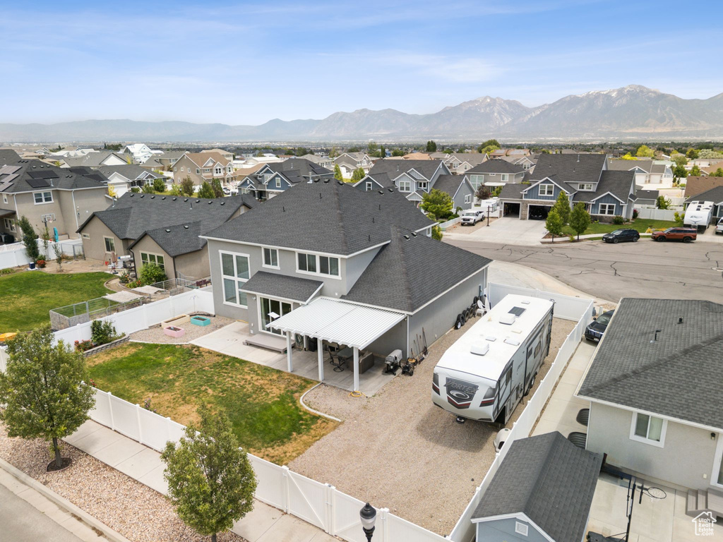 Aerial perspective of suburban area featuring a mountain backdrop
