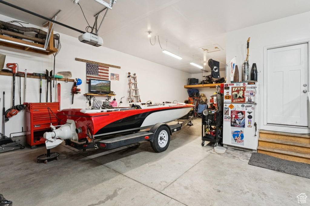 Garage featuring a workshop area and a garage door opener