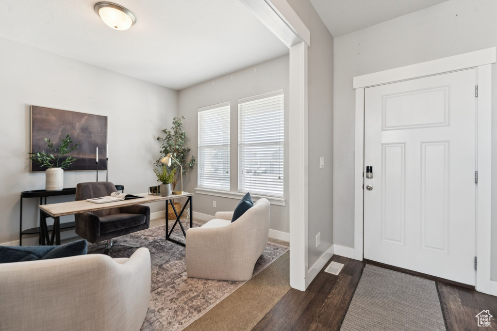 Office area featuring dark wood finished floors and baseboards