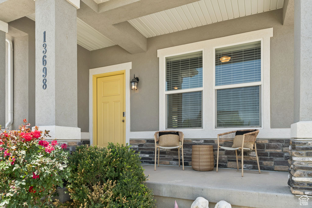 Doorway to property featuring stucco siding