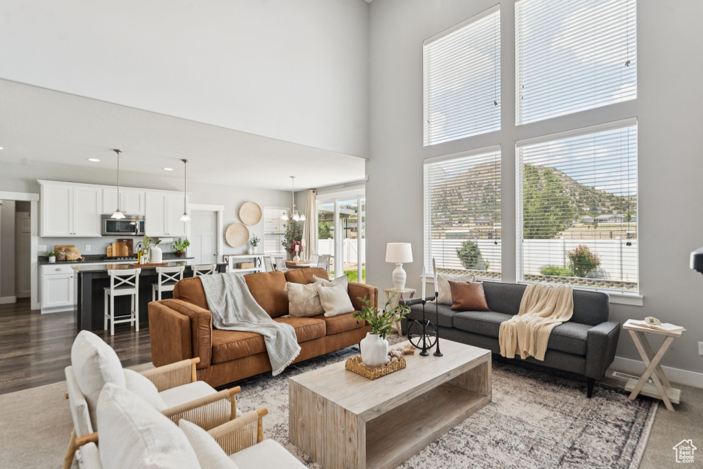 Living room featuring a high ceiling, recessed lighting, and a chandelier