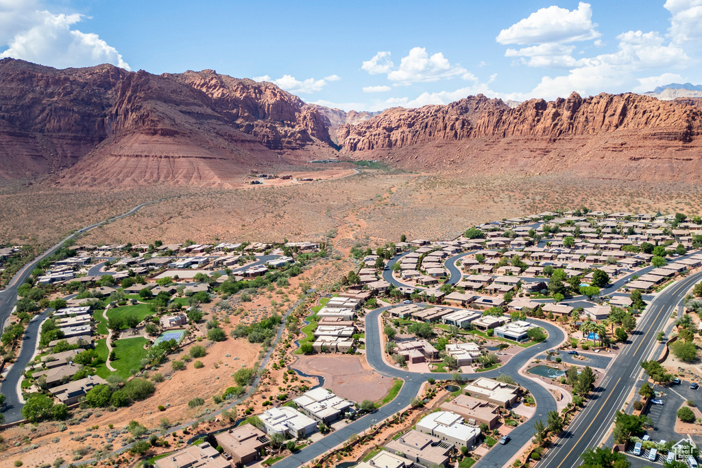 Aerial overview of property's location featuring a mountain backdrop and nearby suburban area
