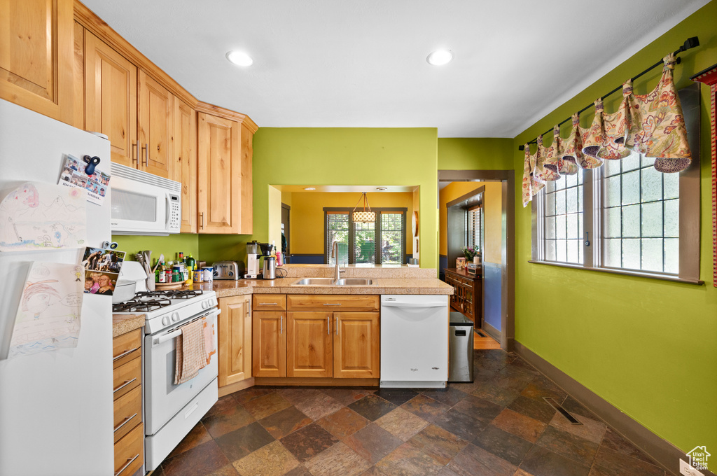 Kitchen with white appliances, tile counters, dark stone finish flooring, a peninsula, and recessed lighting