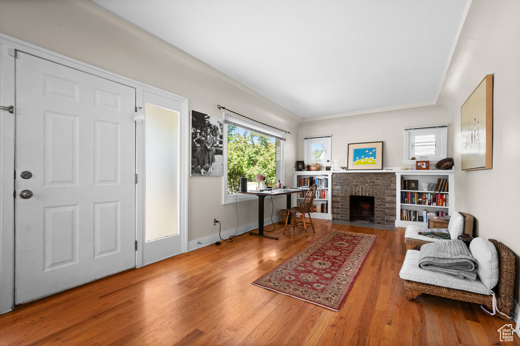 Living area featuring wood finished floors and a brick fireplace