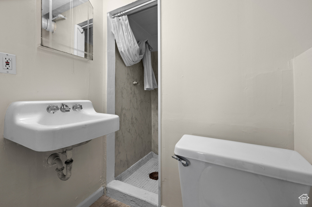 Full bath with a shower stall and toilet