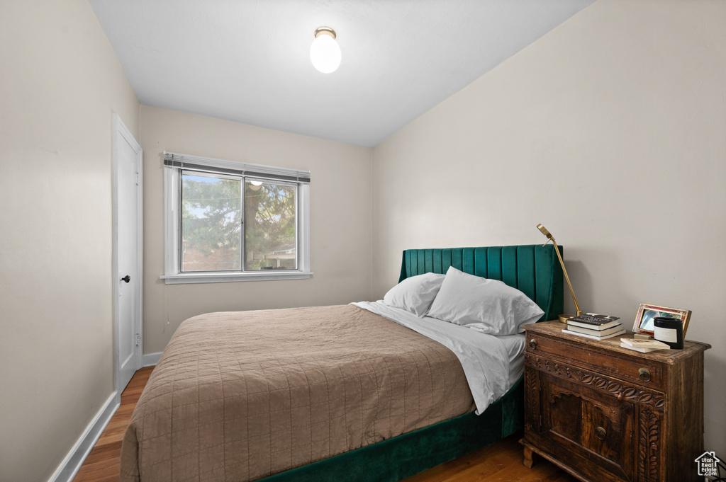 Bedroom featuring wood finished floors and baseboards