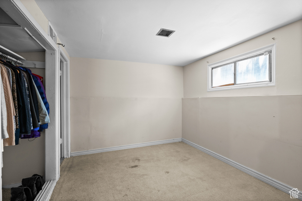 Empty room with carpet flooring and baseboards