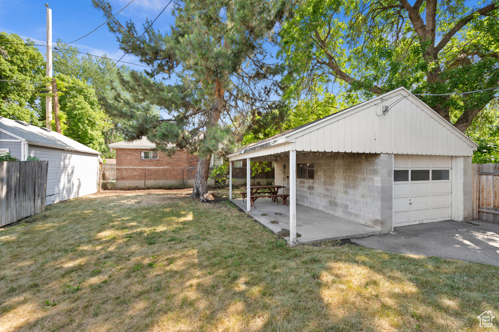 Fenced backyard with a detached garage