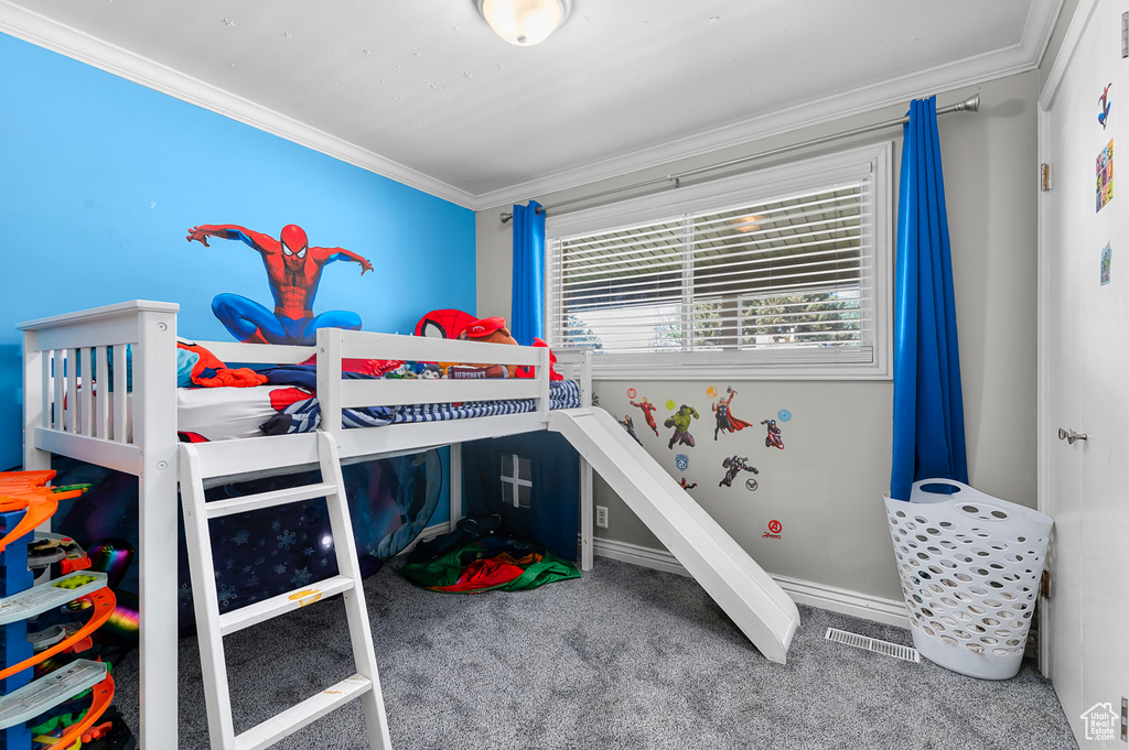Carpeted bedroom featuring ornamental molding