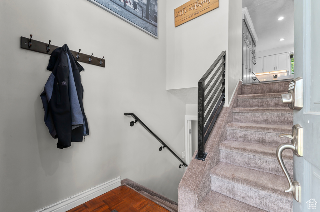 Stairs with baseboards and recessed lighting