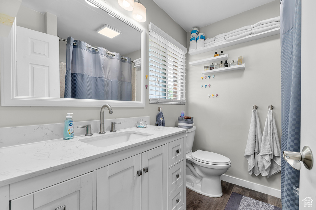 Bathroom featuring vanity and wood finished floors