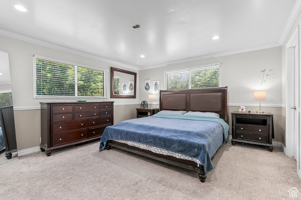 Bedroom featuring light colored carpet, ornamental molding, and recessed lighting