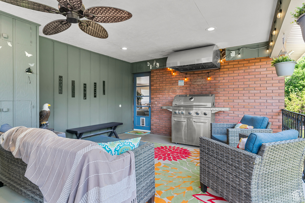 View of patio with area for grilling and ceiling fan