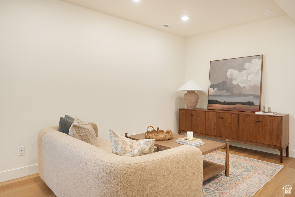 Living room with light wood-style floors and recessed lighting