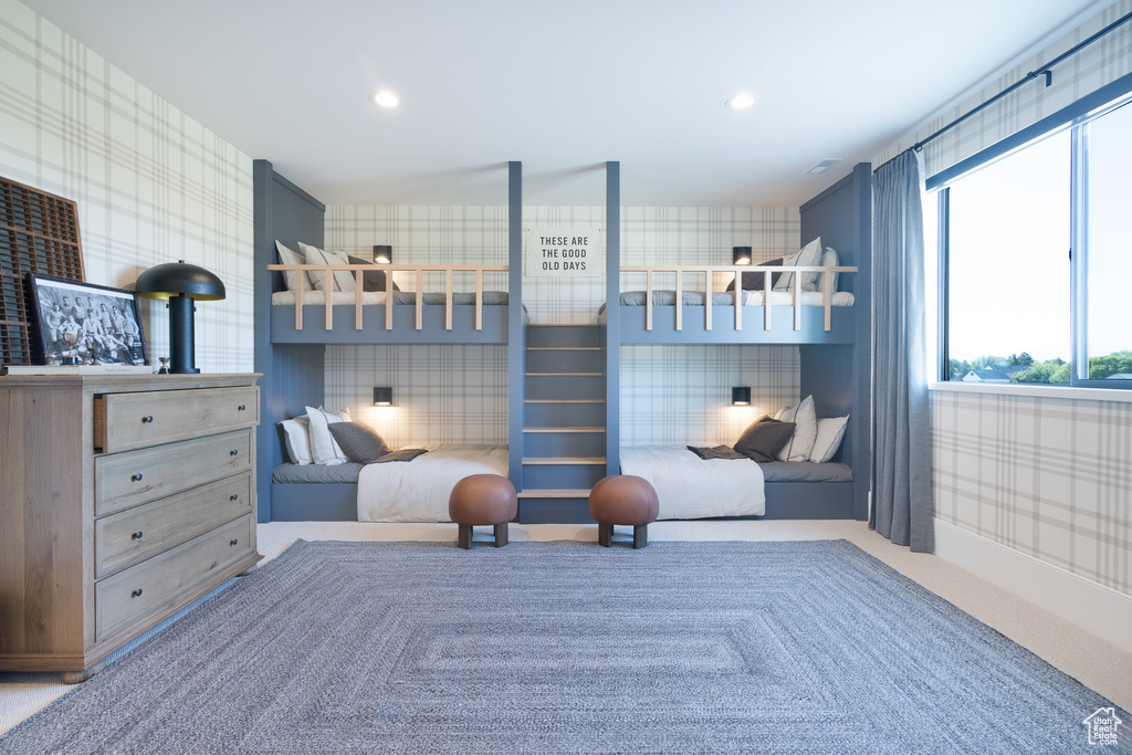 Bedroom with wallpapered walls and recessed lighting