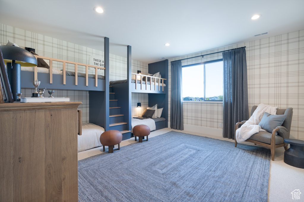 Bedroom featuring wallpapered walls, carpet flooring, and recessed lighting