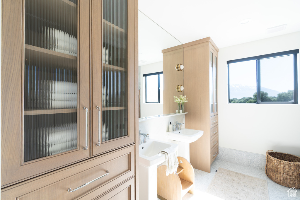 Bathroom featuring baseboards and two sinks