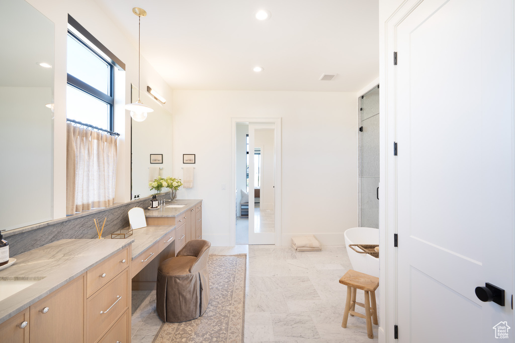 Full bathroom with vanity, a shower, recessed lighting, and a freestanding tub
