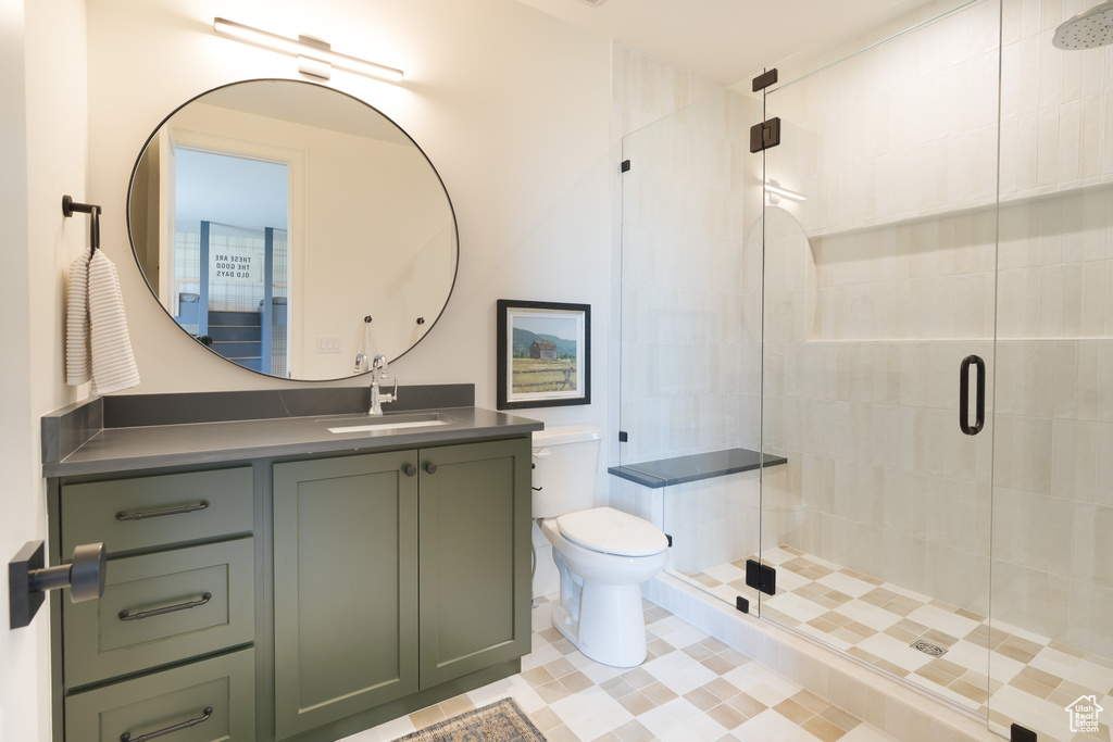 Full bathroom featuring a stall shower and vanity