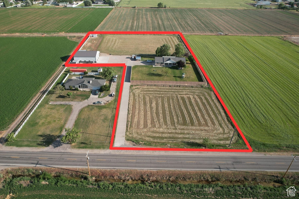 Overview of rural landscape with rows of crops and property parcel outlined