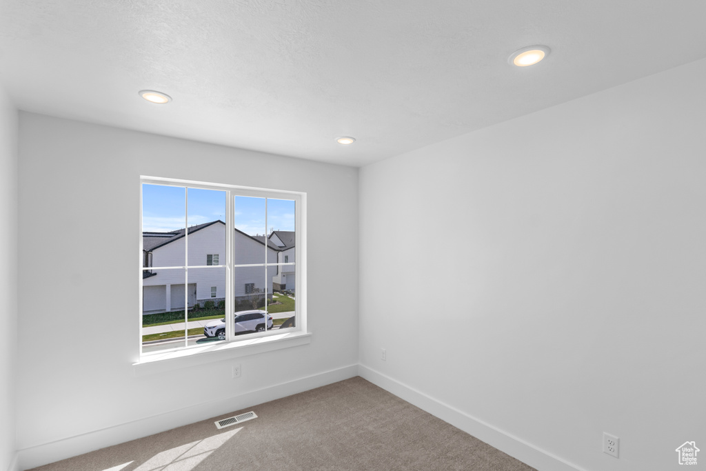 Empty room featuring carpet floors and recessed lighting