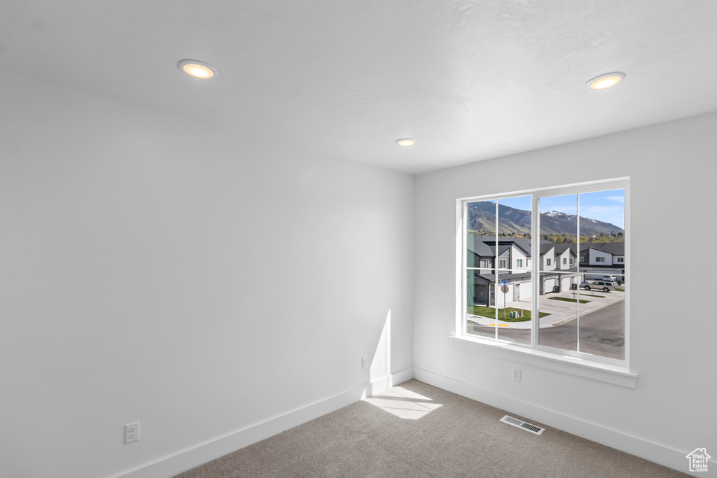 Carpeted spare room with recessed lighting