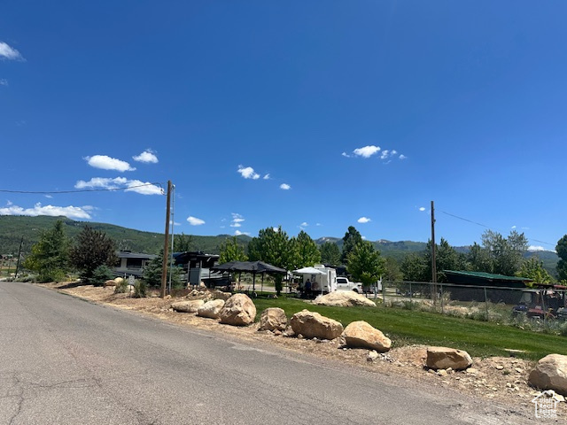 View of asphalt street featuring a mountain view