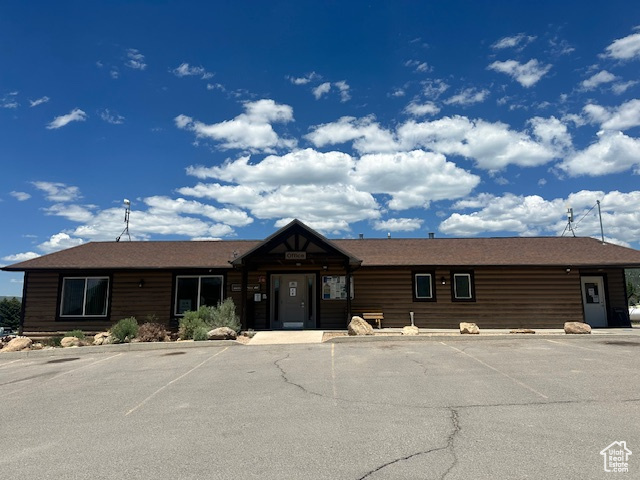 View of property with uncovered parking