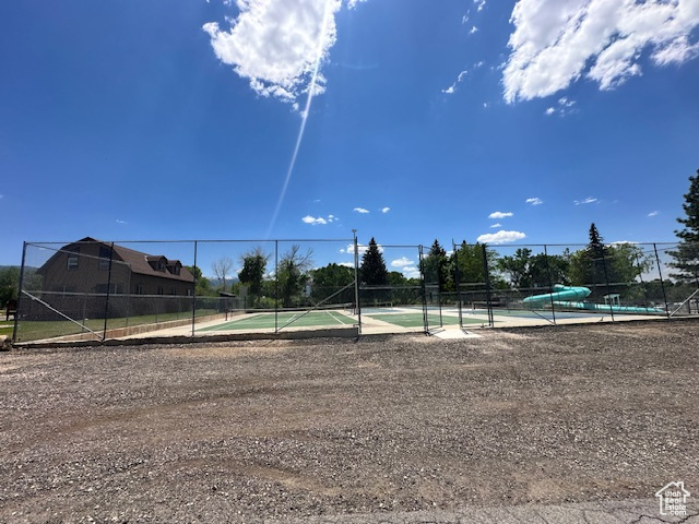 View of community featuring a tennis court