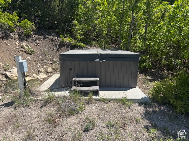 View of outdoor structure featuring a hot tub