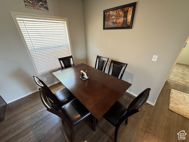 Dining space with wood finished floors and baseboards
