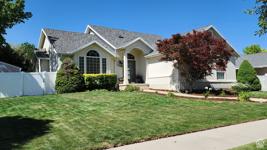 Ranch-style home with stucco siding, a garage, and roof with shingles