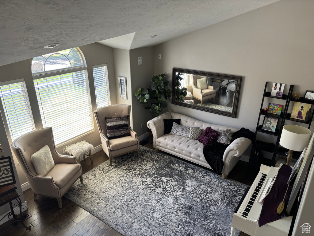 Living room with wood finished floors and a textured ceiling