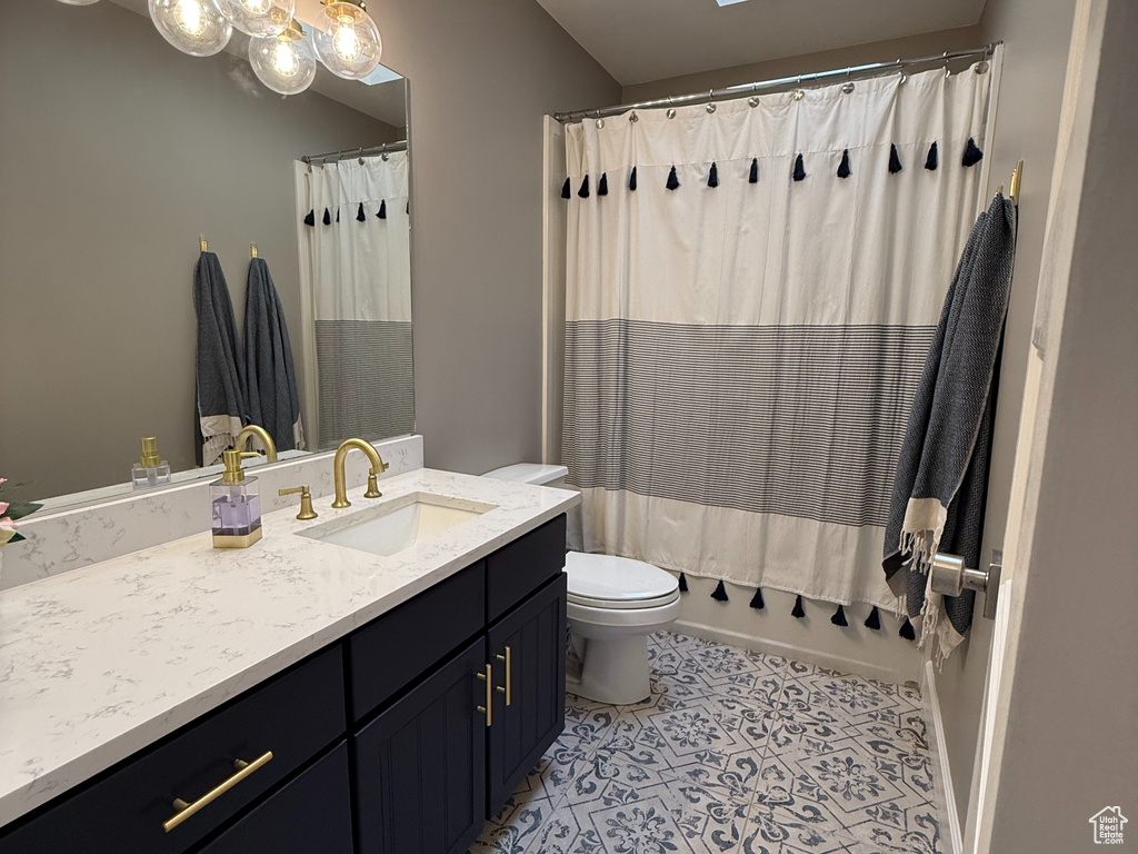 Full bath featuring a skylight and vanity