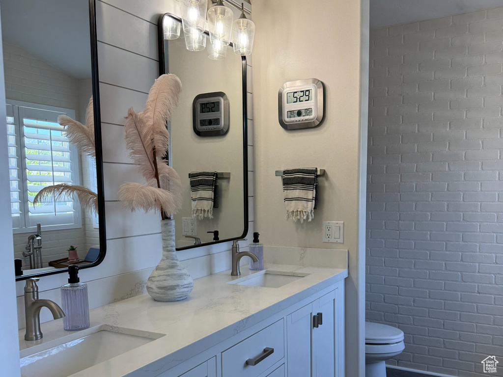 Bathroom with double vanity and toilet