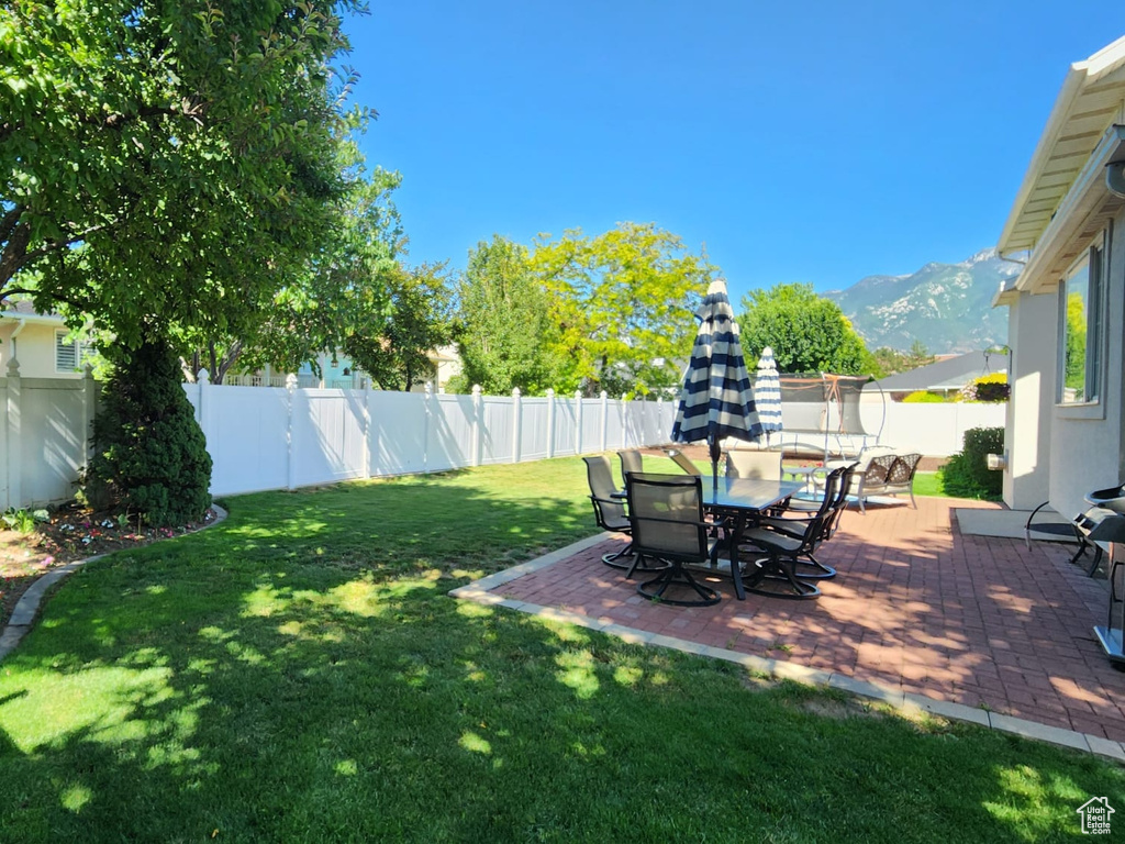 Fenced backyard with a patio area and a mountain view