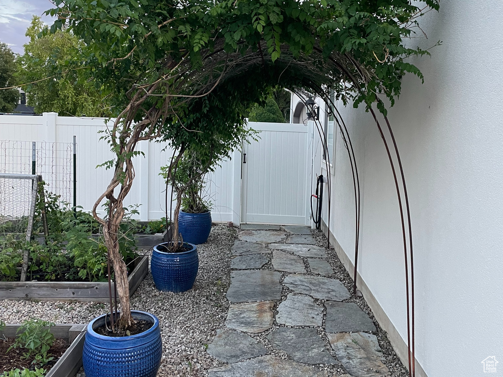 View of patio / terrace with a garden and a gate
