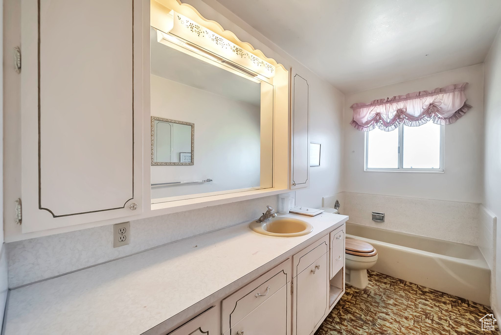 Full bath with vanity and a garden tub