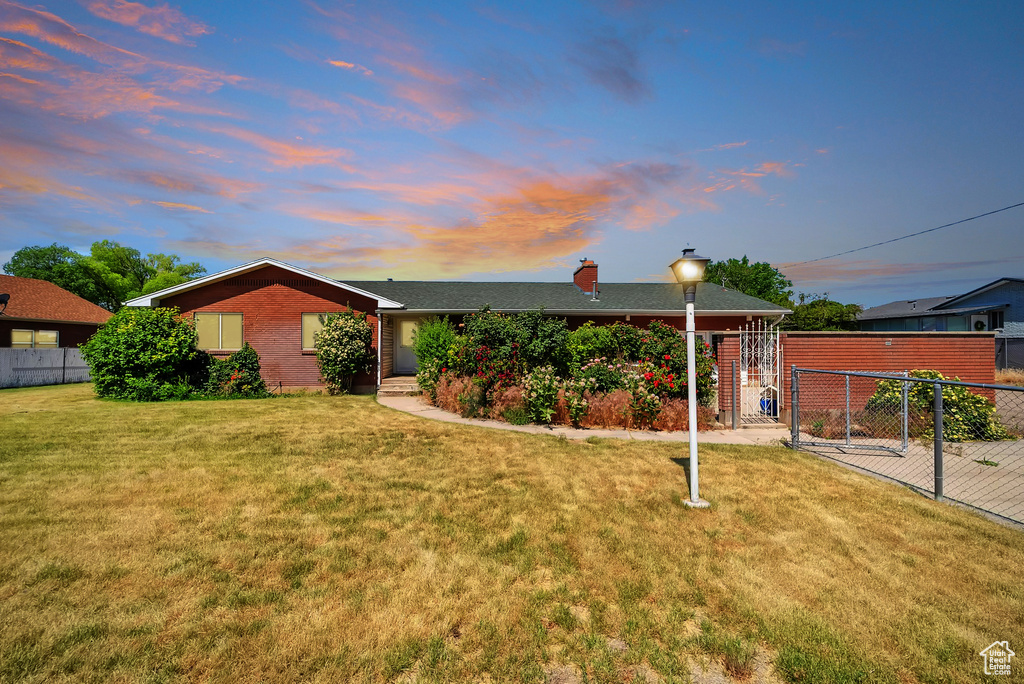 View of front of house with a chimney and brick siding