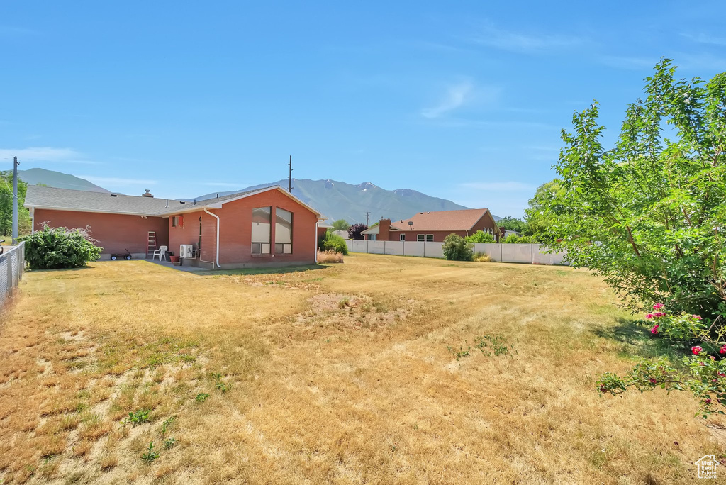 Fenced backyard with a mountain view