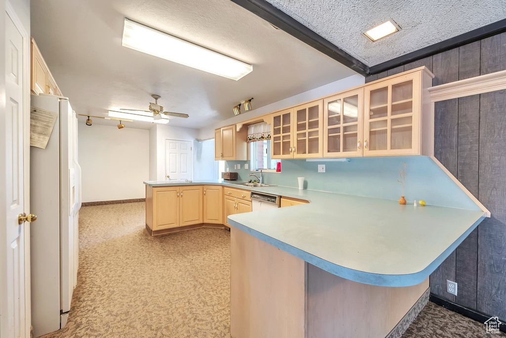 Kitchen with a peninsula, light brown cabinetry, glass insert cabinets, white refrigerator with ice dispenser, and dishwashing machine