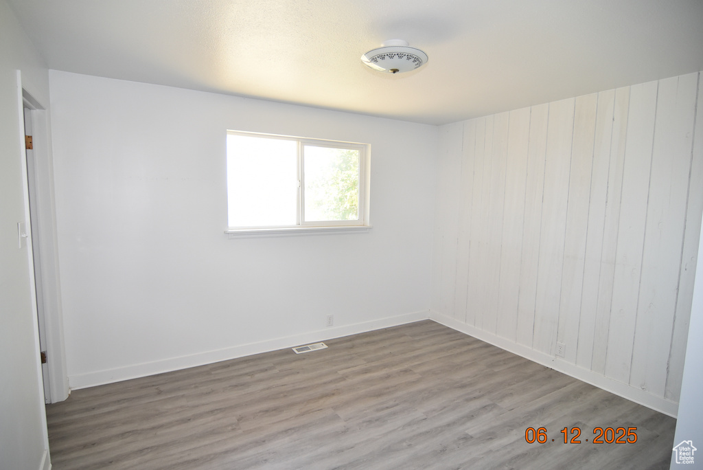 Empty room with wood finished floors and baseboards