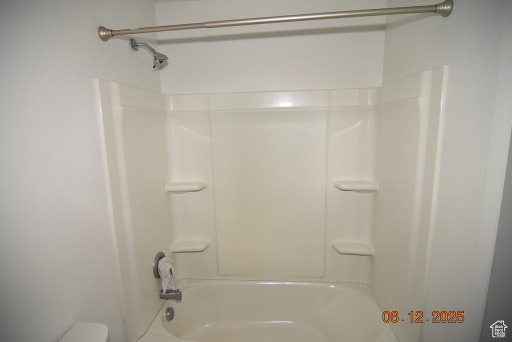 Full bathroom featuring bathing tub / shower combination and toilet