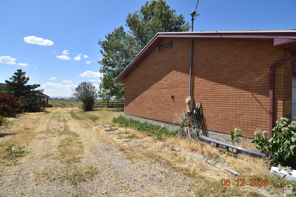View of side of home with brick siding