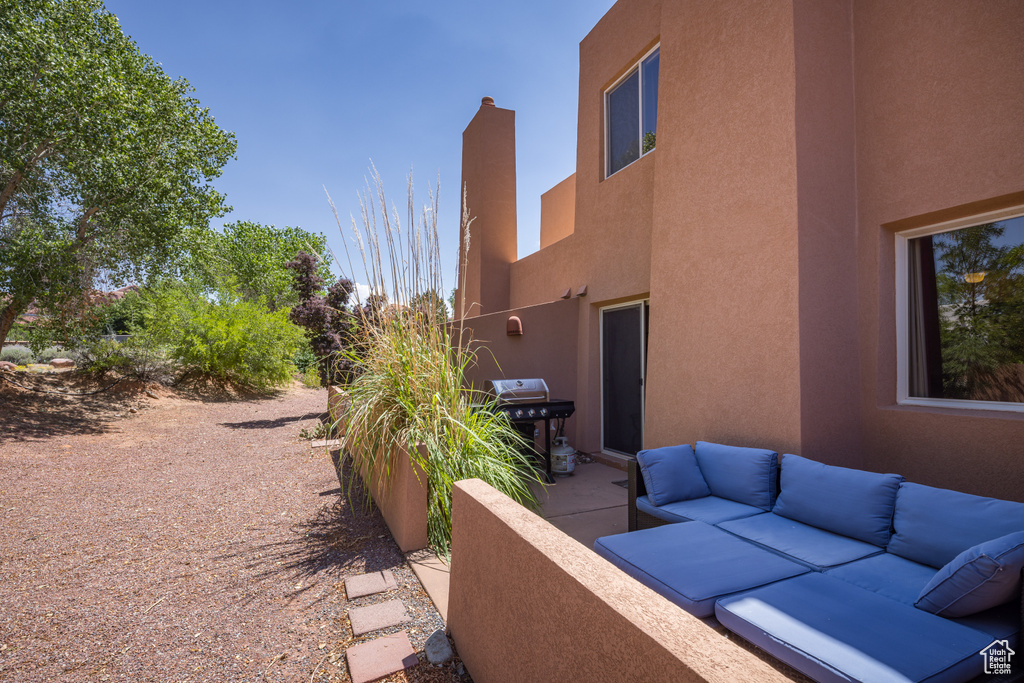 View of patio with an outdoor hangout area and area for grilling