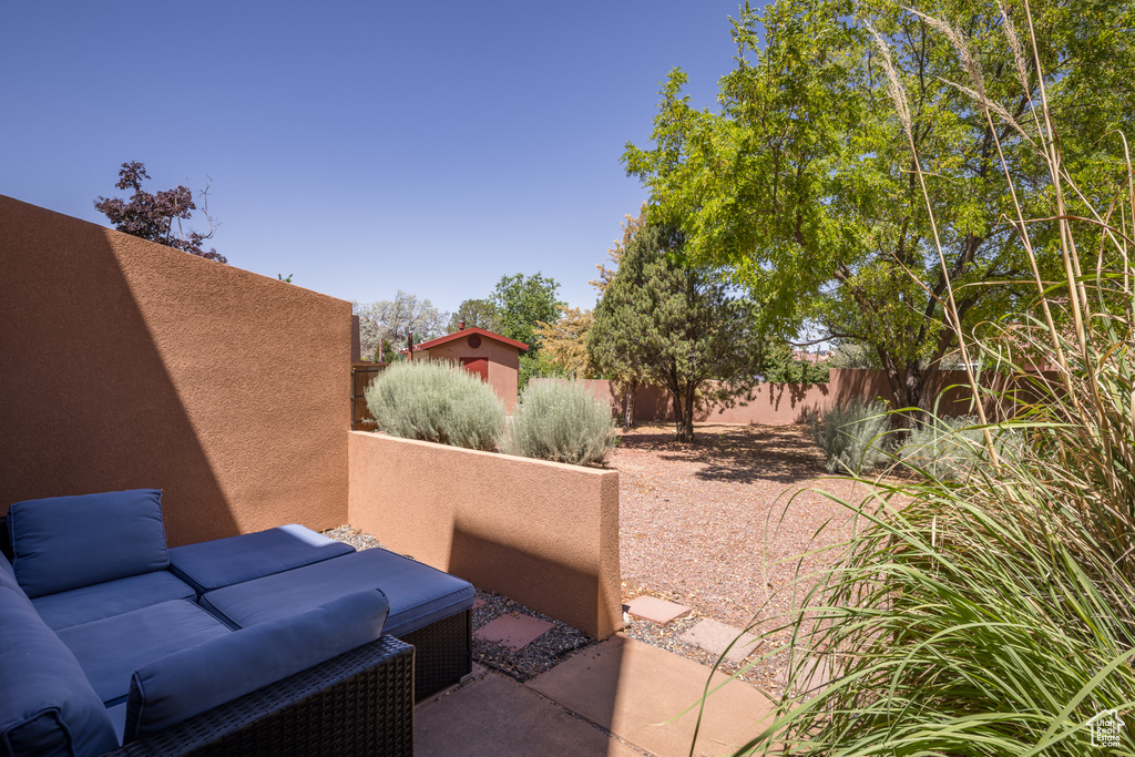 Fenced backyard featuring a patio area and an outdoor living space
