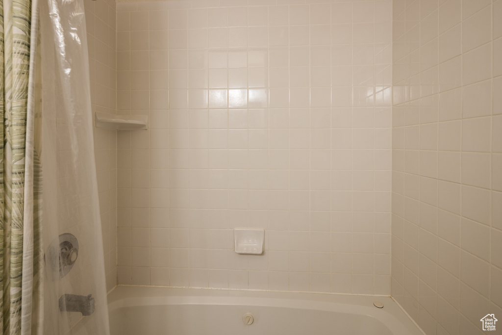 Bathroom featuring shower / tub combo with curtain