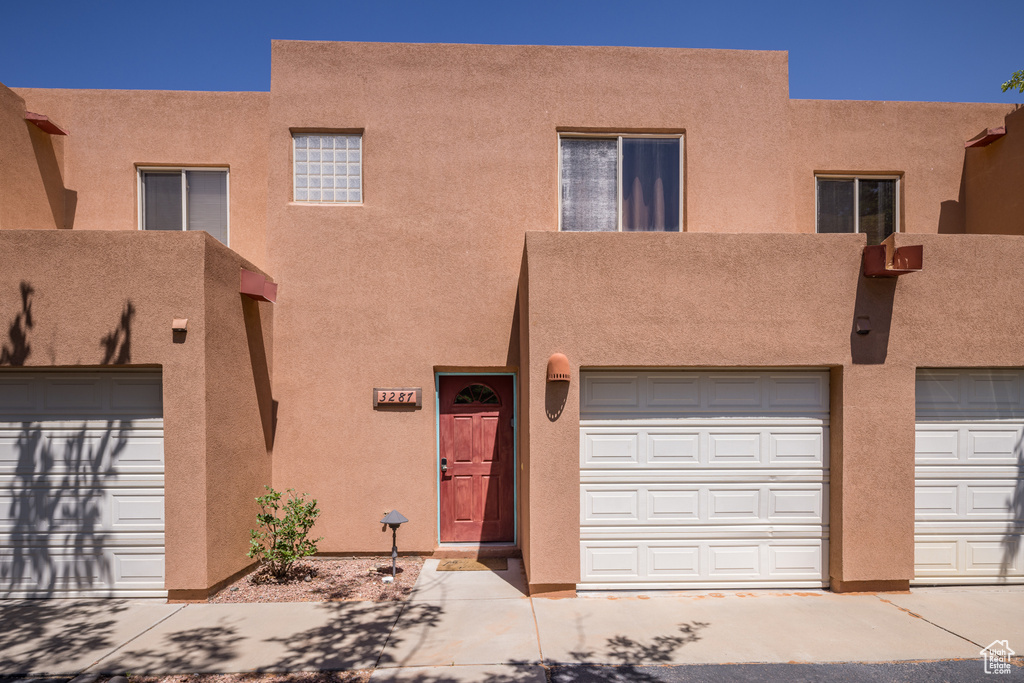 Pueblo-style home with stucco siding
