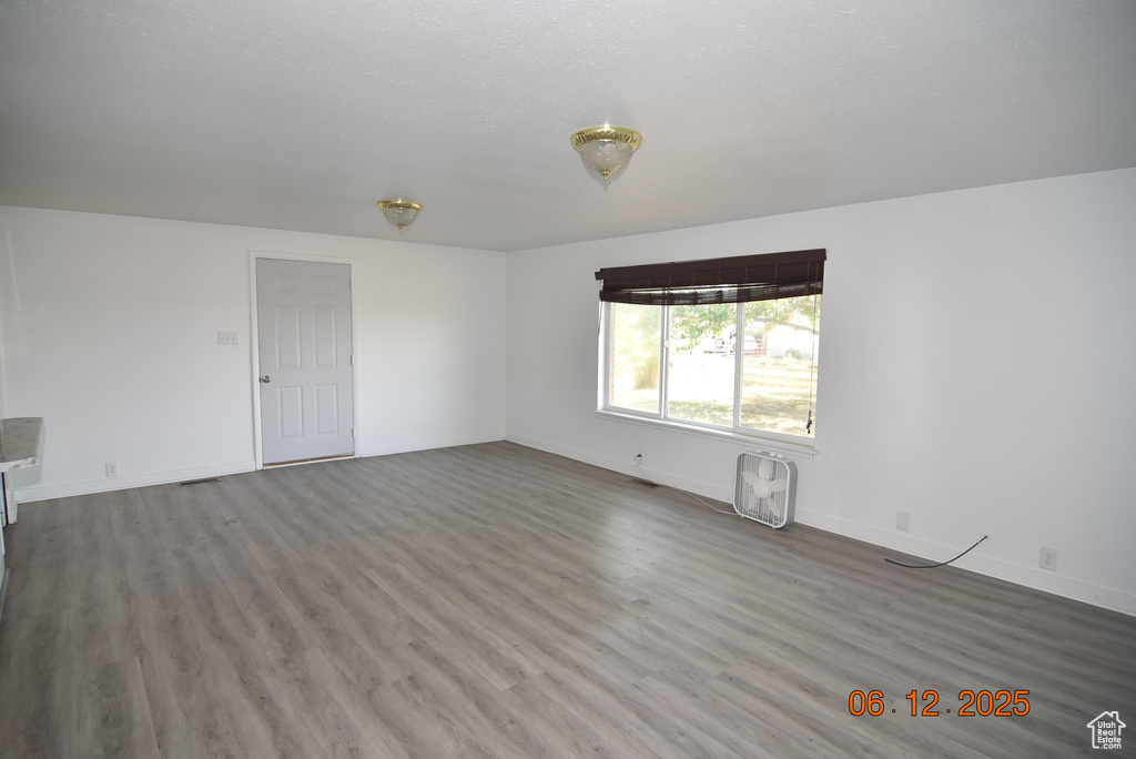 Unfurnished living room with wood finished floors