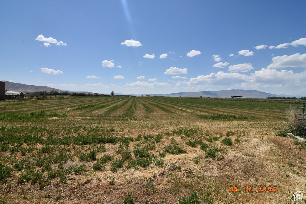 View of mountain backdrop featuring rural landscape